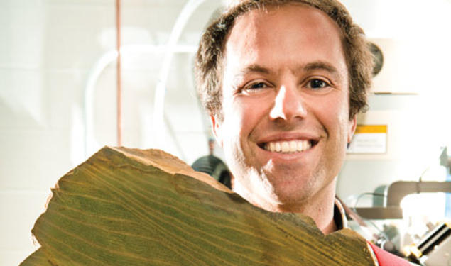 Adam Maloof prepares to grind a rock that records tidal cycles 640 million years ago.