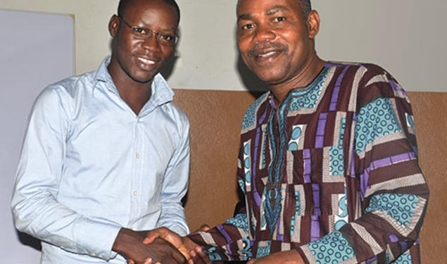 Leonard Wantchekon, right, congratulates Romaric Samson on earning a master’s degree from the institute in Benin, West Africa, that Wantchekon founded.