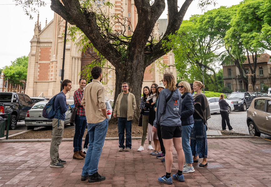 Participants gather around Matias Avramow, a climate and environment reporter for La Naci&oacute;n, outside the San Isidro Cathedral.