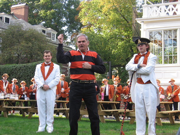 Tom Meeker ’56 leads a locomotive cheer in 2006, with student conductor Charles Pence ’07 and drum major Charlie Bergen ’07 looking on