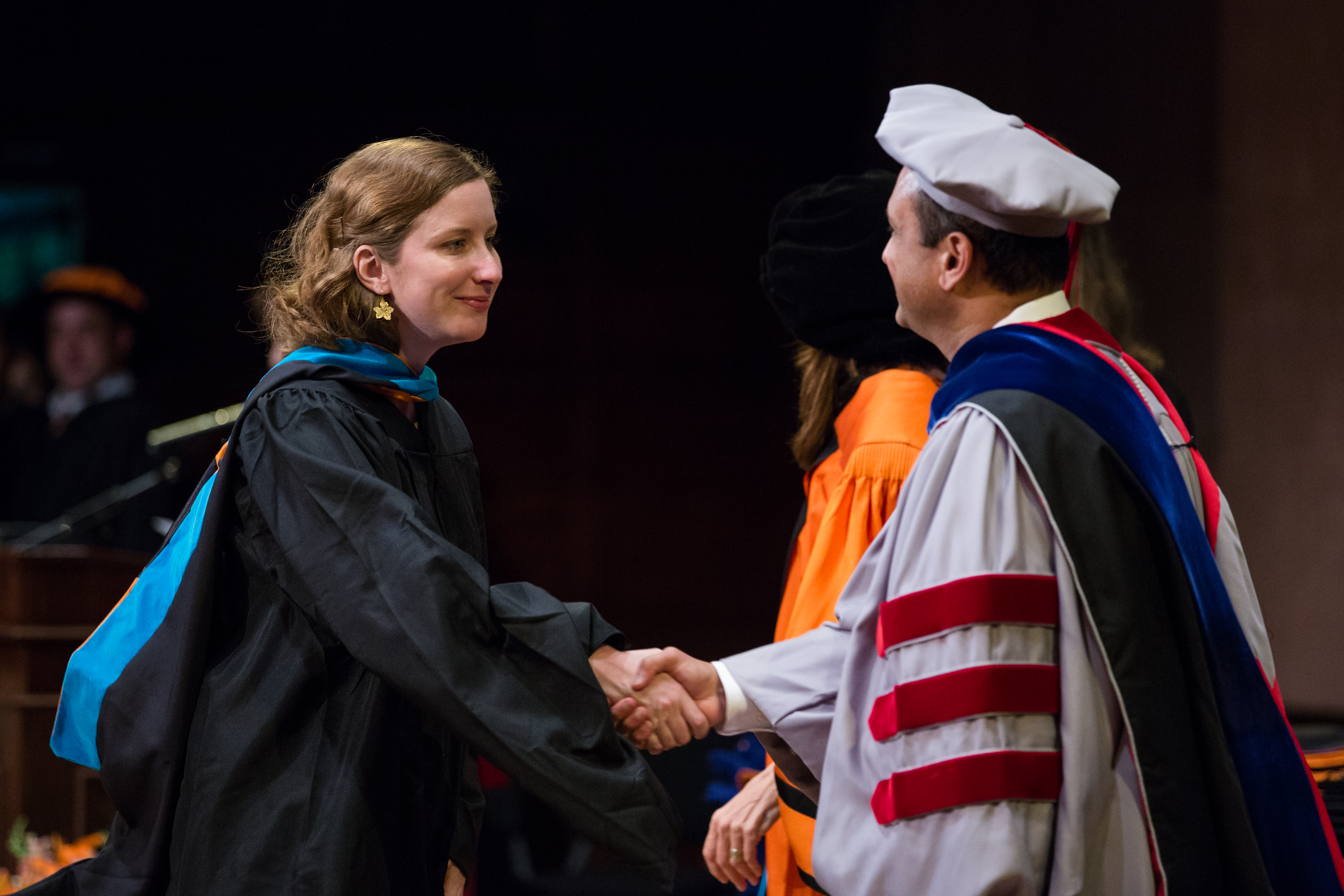 Caitlin Tulloch *15 shakes the hand of a professor at her SPIA graduation in 2015.