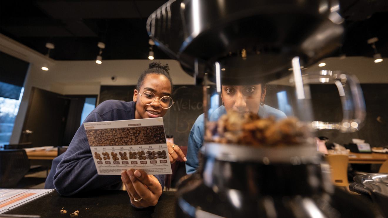 Graduate students Néhémie Guillomaïtre-Fischer, left, and Ananya Chakravarti decide on a dark roast for their coffee beans.