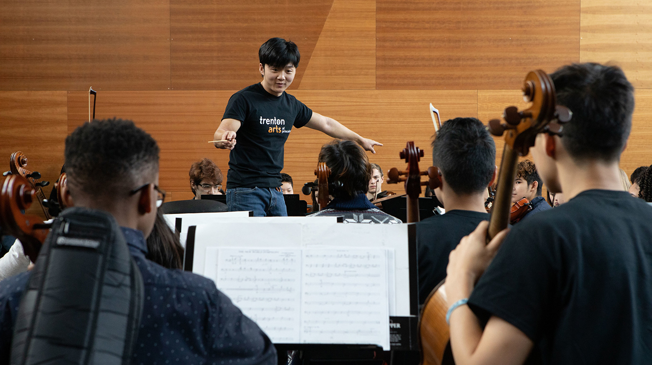 Lou Chen ’19 conducts the Trenton Youth Orchestra, part of the Trenton Arts at Princeton program, at the Lewis Center for the Arts in February 2020. 