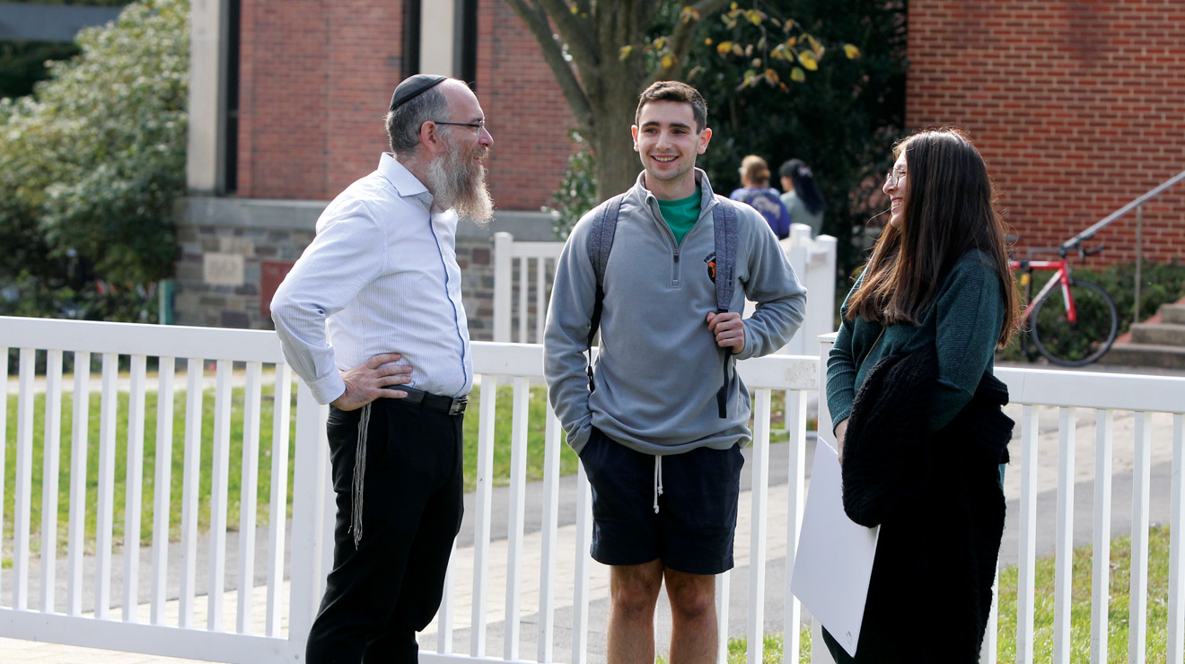 JEWISH_Rabbi Eitan Web.jpg From left, Chabad chaplain Rabbi Eitan Webb, Zachary Dorff ’25, and Gitty Webb, Chabad program director, at a protest in October 2023.