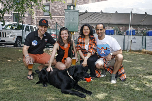 At left, Mark Quinlan ’94 with his wife, Dara, and dog, Stretch; at right are Nawaf Al-Saban ’94 and his wife, Maryam.