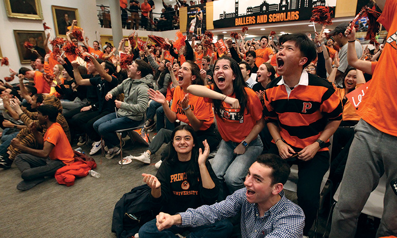 Students cheering at a watch party