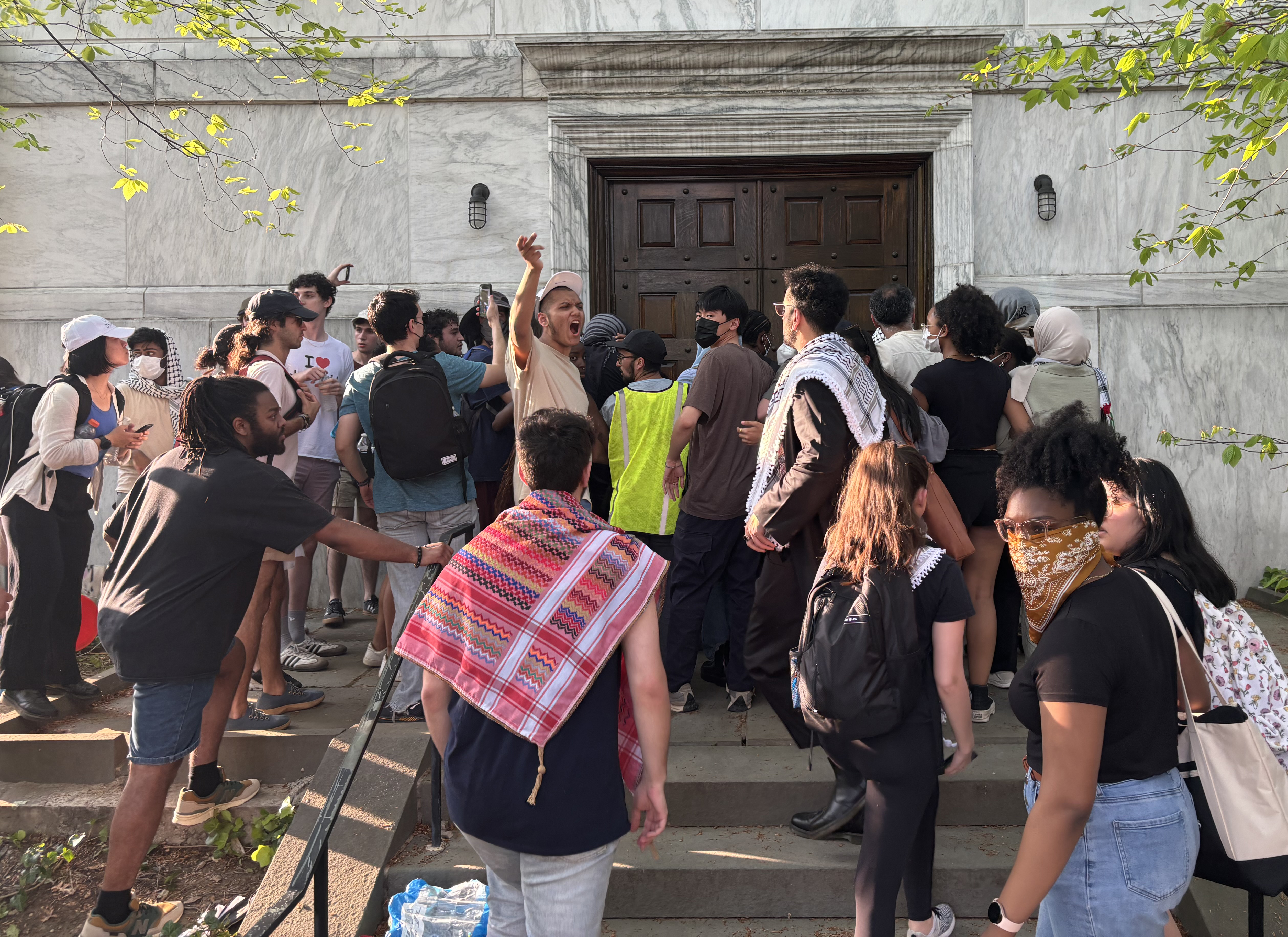 Protesters gather behind Clio Hall.