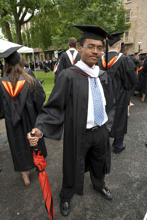 Milton P. Wilkins ’09, with an umbrella at the ready. Skies cleared for Commencement after showers earlier in the morning.