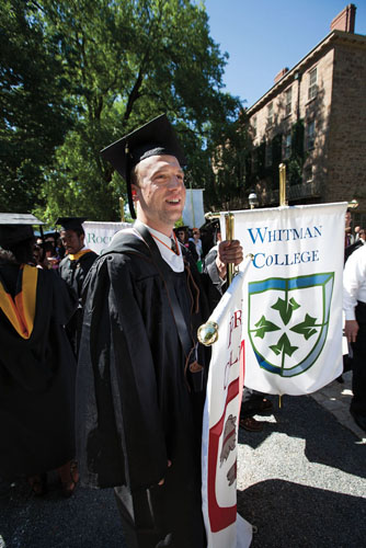 Zak Hermans &rsquo;13 carries the Forbes College banner.