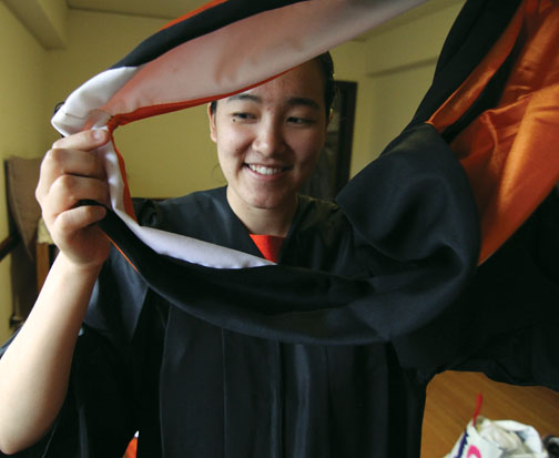 Author Angela Wu &rsquo;12 tries on graduation garb.