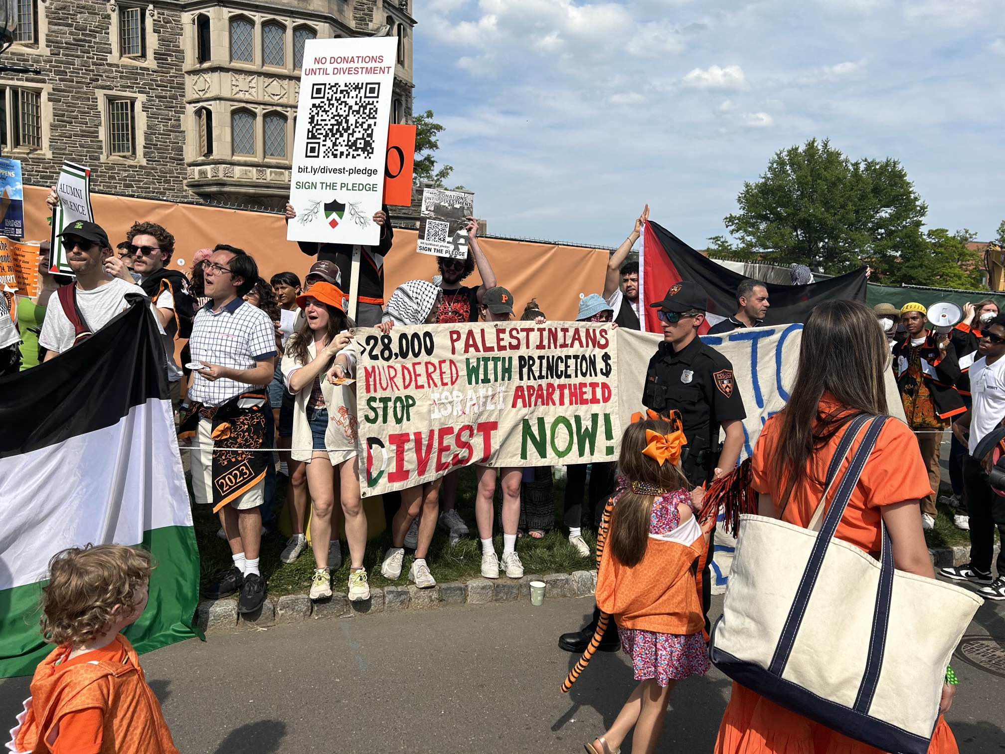 Protesters hold signs at the P-rade; one reads: "28,000 Palestinians murdered with Princeton $. Stop Israeli apartheid. Divest Now!"