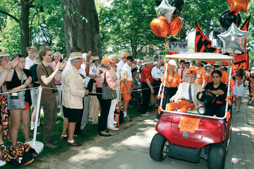 LIVE.R-BKS23_Warnock281.jpg Above, Class of 1923 Cane honoree Malcolm Warnock ’25, driven by Ariana Vera ’12, leads members of the Old Guard in the P-rade.