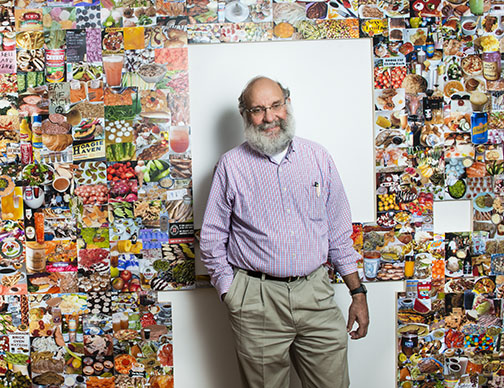 Dean of the Faculty David Dobkin with parts of the Lewis Center exhibition created from his collections.
