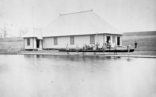 NB_DigiLibrary7500.jpg Crew members prepare for practice in front of the original campus boathouse in 1875