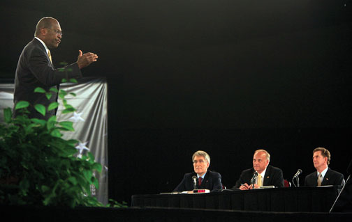 Republican presidential hopeful Herman Cain responds to a question from the Palmetto Freedom Forum’s panelists: from left, ­Professor Robert George, Rep. Steve King, and Sen. Jim DeMint.