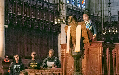 Students read a manifesto during the Chapel gathering; Naimah Hakim ’16 is in the pulpit at upper right.