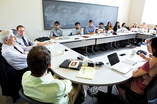 Students listen to Peruvian author Mario Vargas Llosa, left, during a seminar on his writings.