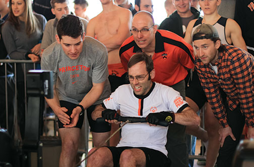 From left, Ted Moskovitz ’17, Greg Hughes ’96, and Keanan Clark ’13 cheer on Special Olympics rower Antony Pontoriero at the Crash P.