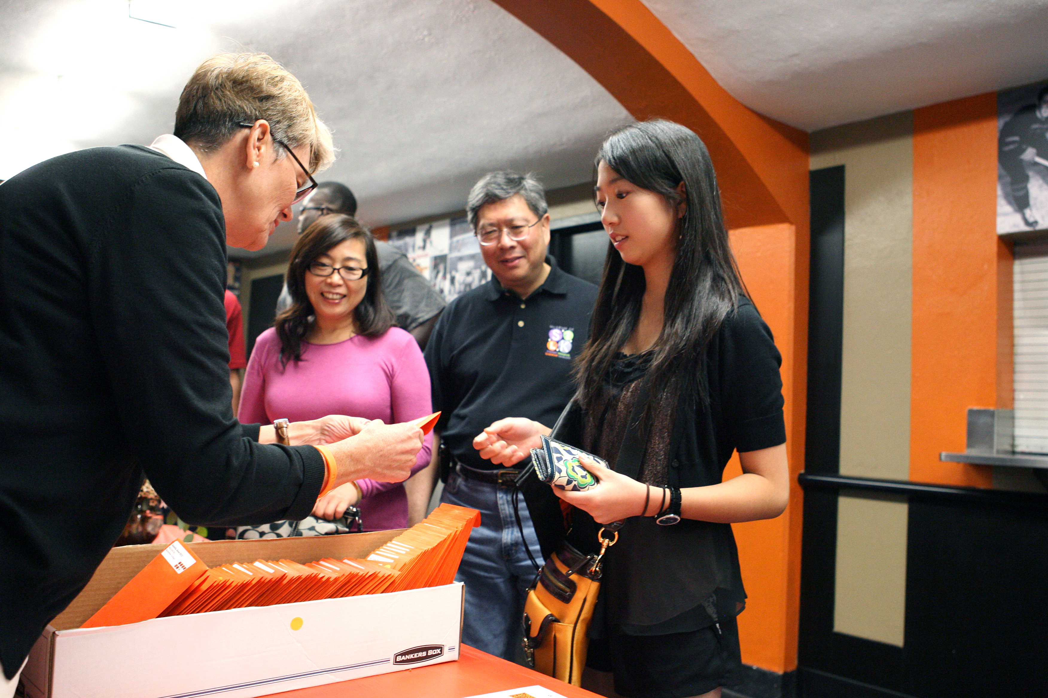 Stephanie Liu '15 receives her check-in package from Amy Campbell of the office of campus life.