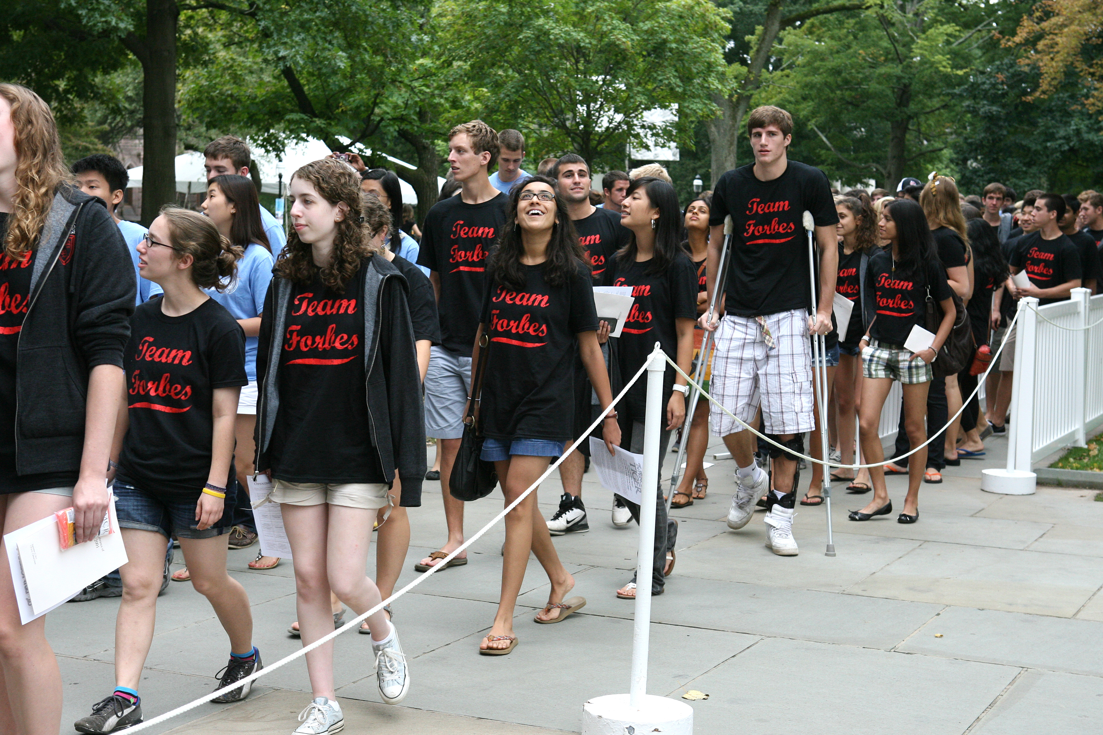 At the Pre-rade, freshmen enter campus with classmates from their residential colleges, wearing college-specific T-shirts.