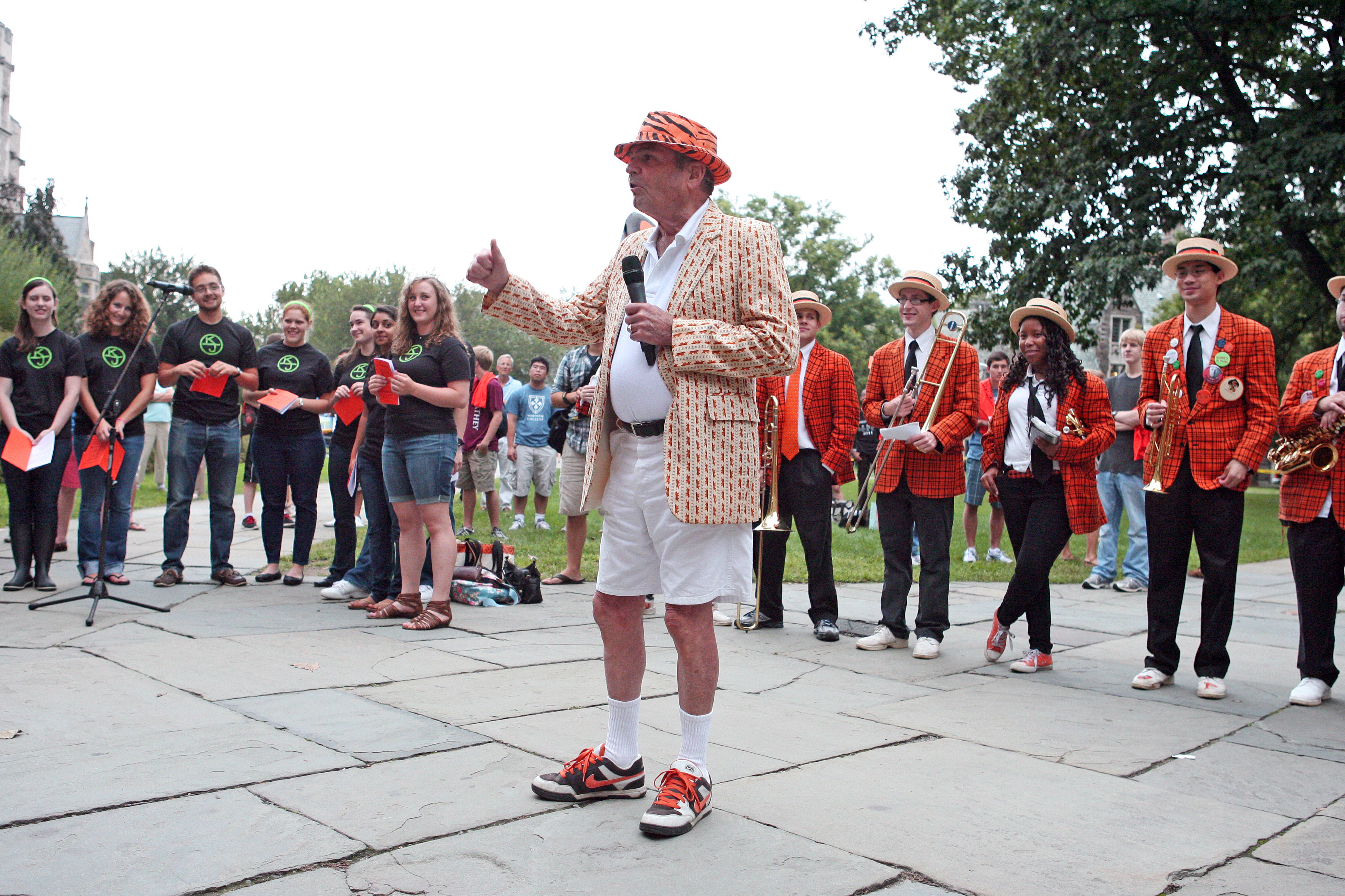 Tom Meeker '56, a longtime class secretary and lover of all things orange and black, teaches the new class the locomotive cheer.