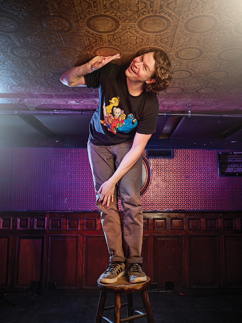 Zach Zimmerman on stool touching the ceiling