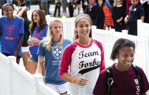 Freshmen enter the University Chapel for Opening Exercises wearing the colors of their residential colleges.