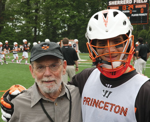 Men’s lacrosse faculty fellow John McPhee ’53, with defenseman Rob Castelo ’14, describes the sport as “football, basketball, and ice hockey in an advanced state of evolution.”