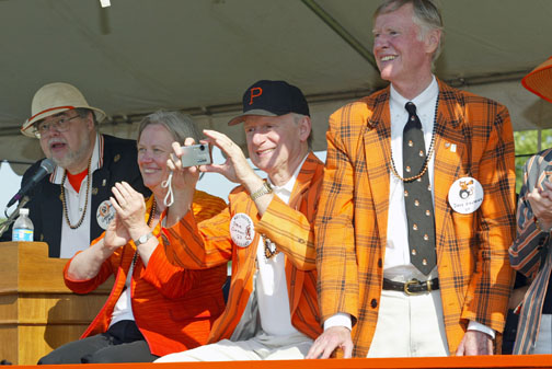 In the P-rade reviewing stand are, from left, announcer Gregg Lange ’70; President Tilghman; Stephen Oxman ’67, chairman of the executive committee of the trustees; and David Siegfried ’64, president of the Alumni Association. 