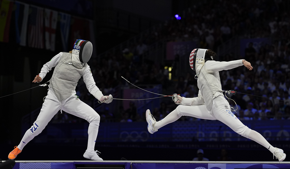  Maia Weintraub ’25, right, lunges toward Italy’s&nbsp;Arianna Errigo in the women’s team foil&nbsp;gold medal match.