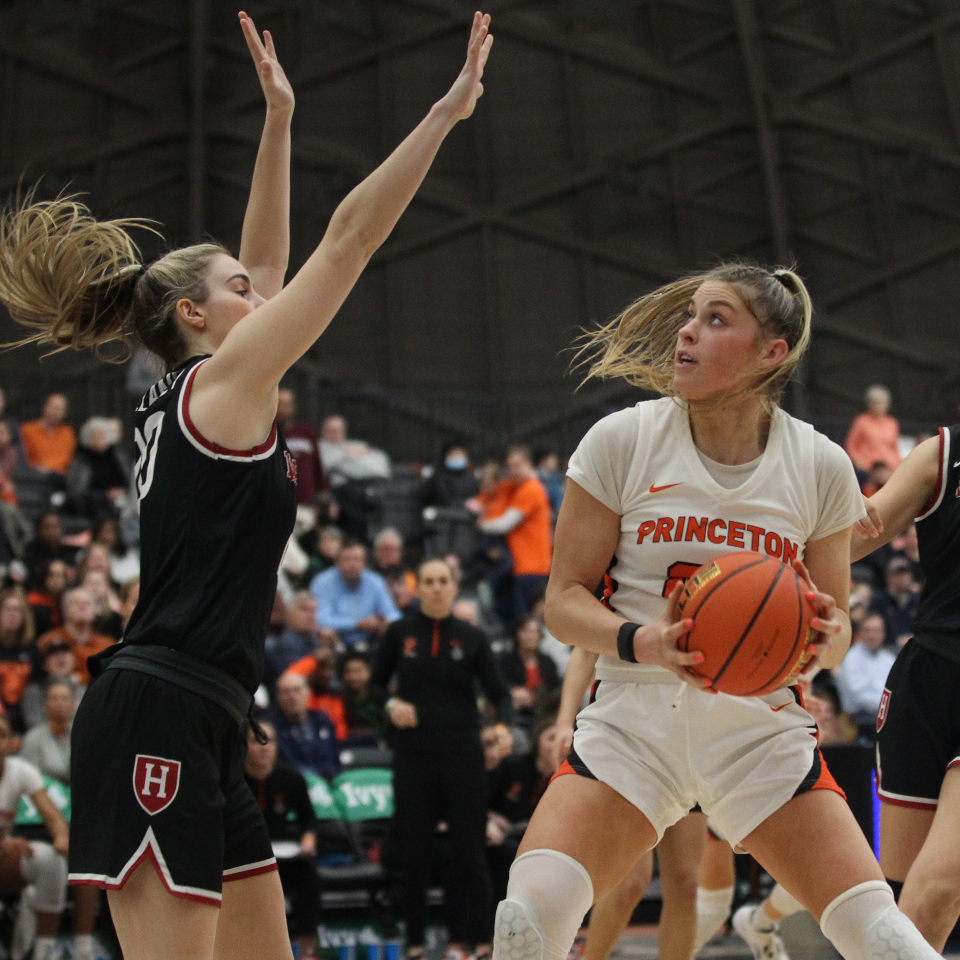 Ellie Mitchell holds ball and looks toward basket