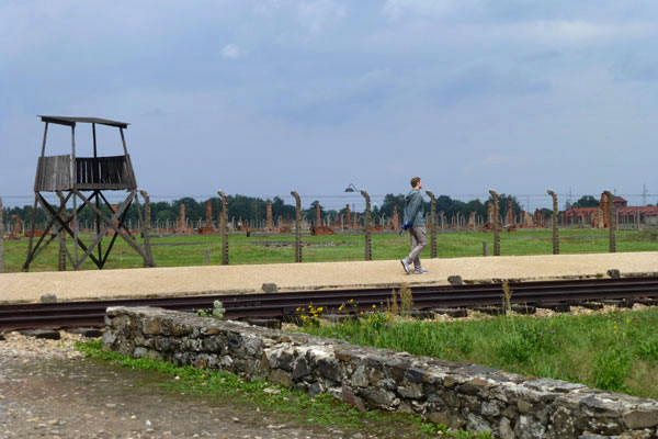 poland4.jpg All four of Silberman’s grandparents were Polish Jews. A grandfather, a tailor, survived five Nazi concentration camps. Here, he surveys the Birkenau camp.