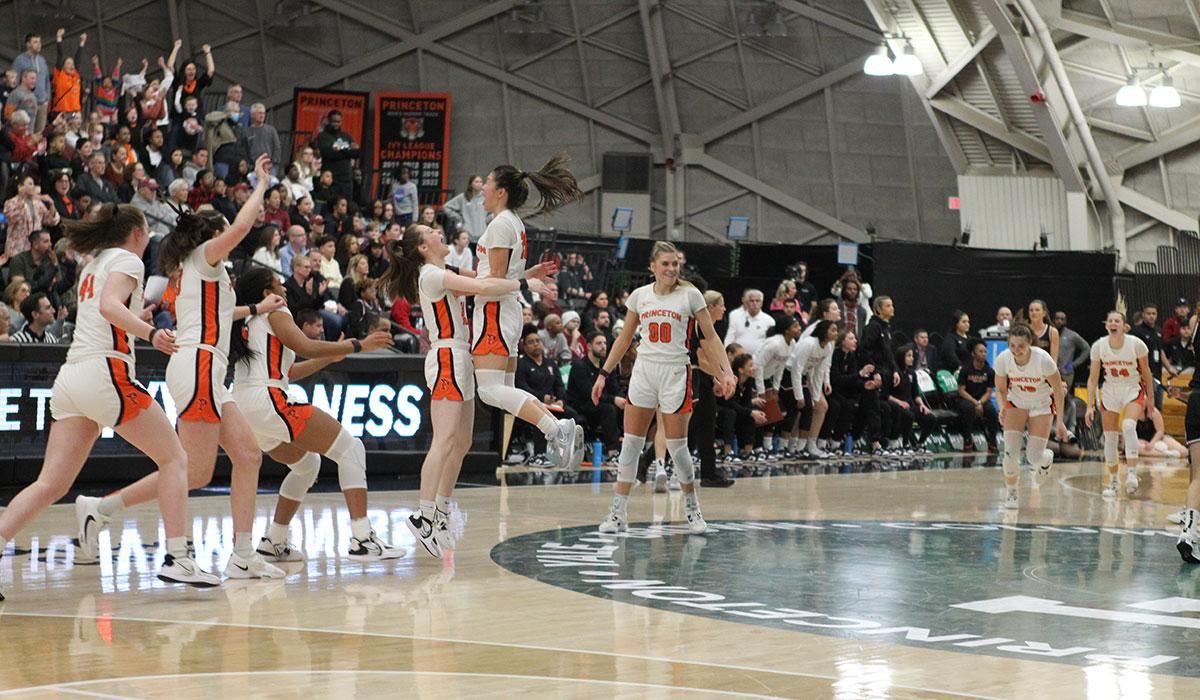 wbb-celebration.jpg Players celebrating on court with arms raised