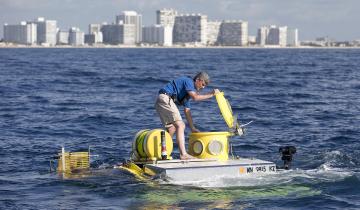 In this photo from June 2013, Stockton Rush ’84 opens the hatch on submersible “Antipodes,” which OceanGate used to offer scientists and wildlife officials a close-up look at the invasive lionfish deep in the waters off South Florida.