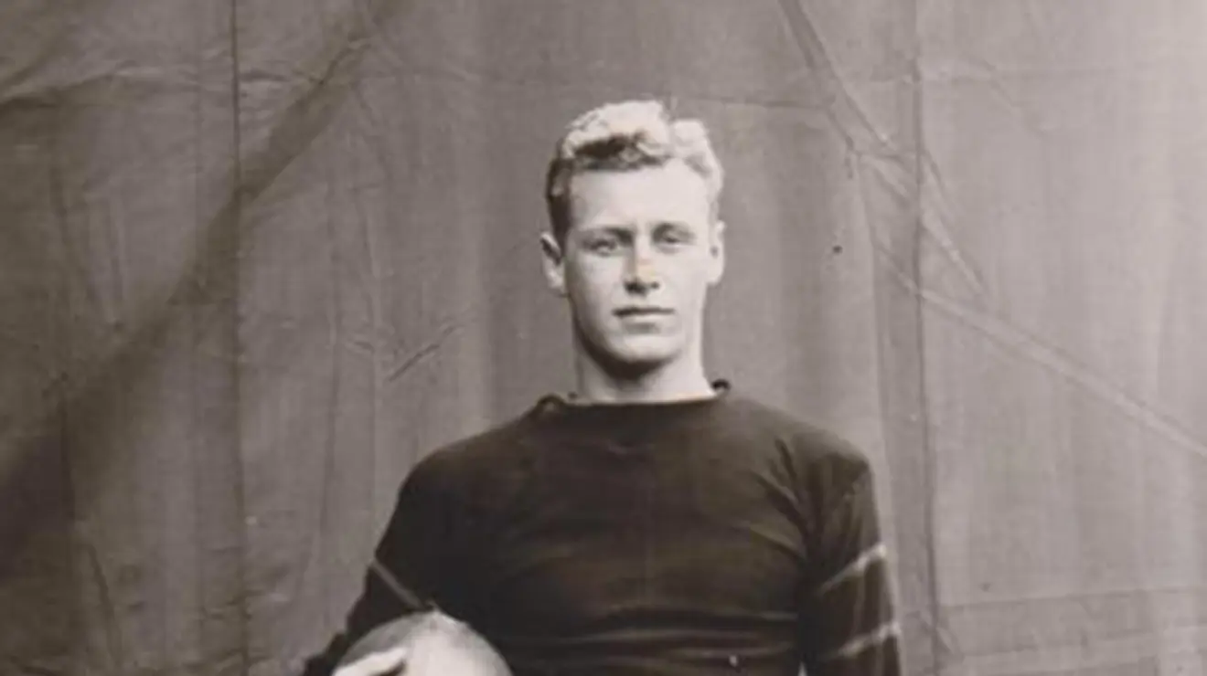 HobeyBaker2_FootballCaptain1913.jpg Black and white photo of Hobey Baker holding a football.