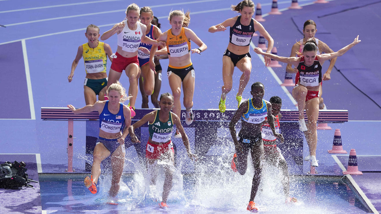 Lizzie Bird ’17, top, clears the hurdle on the water jump in the women’s 3,000-meter steeplechase.