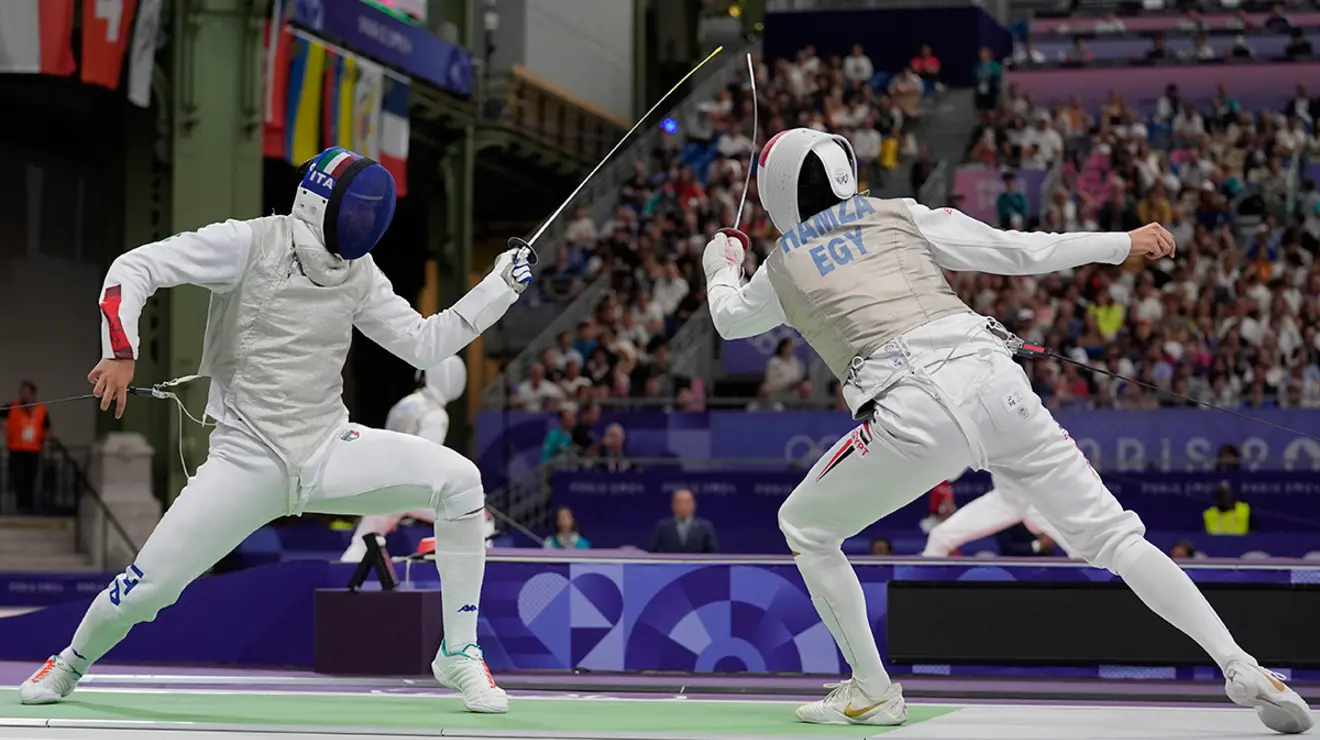 Egypt’s Mohamed Hamza ’23, right, competes with Italy’s Filippo Macchi in the men’s individual foil quarterfinals at the 2024 Summer Olympics at the Grand Palais July 29.