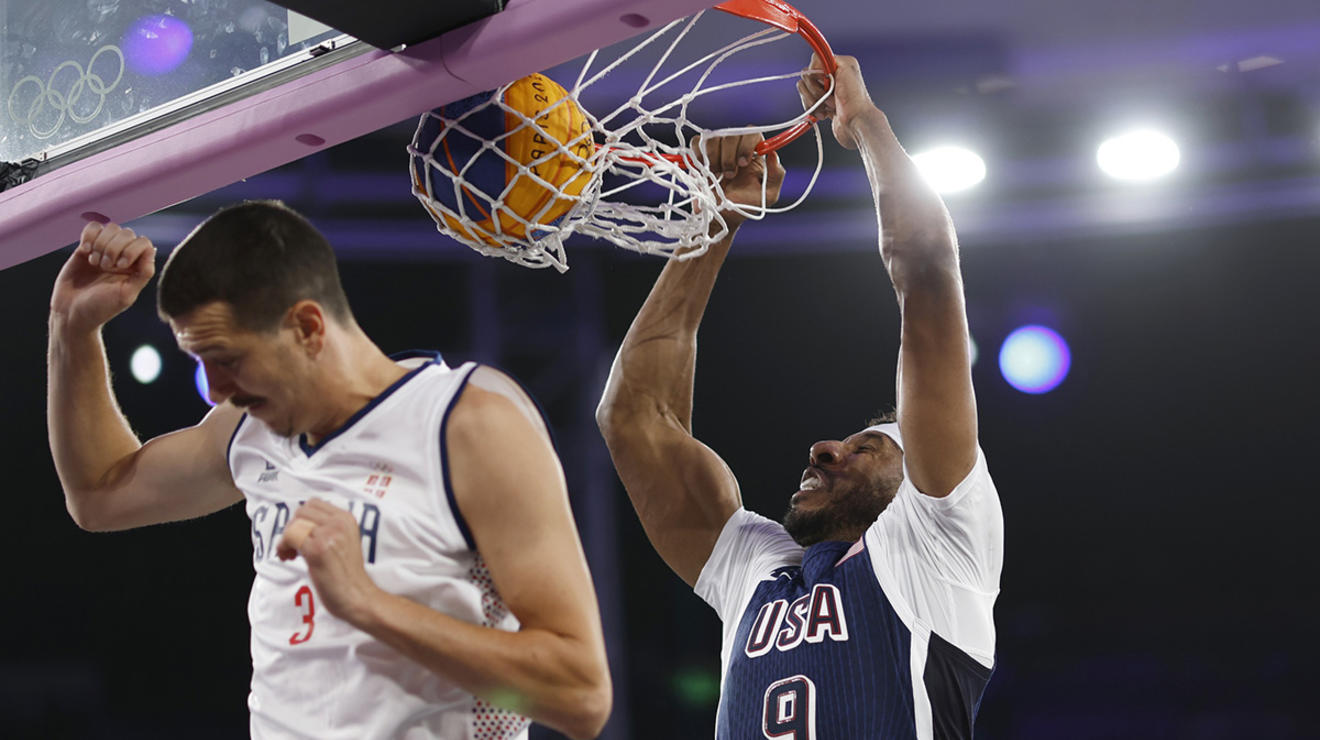 Kareem Maddox dunks over Serbia’s Strahinja Stojacic in a July 30 game. The U.S. improved to 2-4 in pool play with wins over France and China Aug. 2.