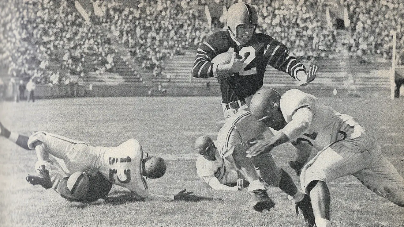 kazmaier-1951_rev.png Football player Dick Kazmaier '52 tries to dodge a tackler in 1951