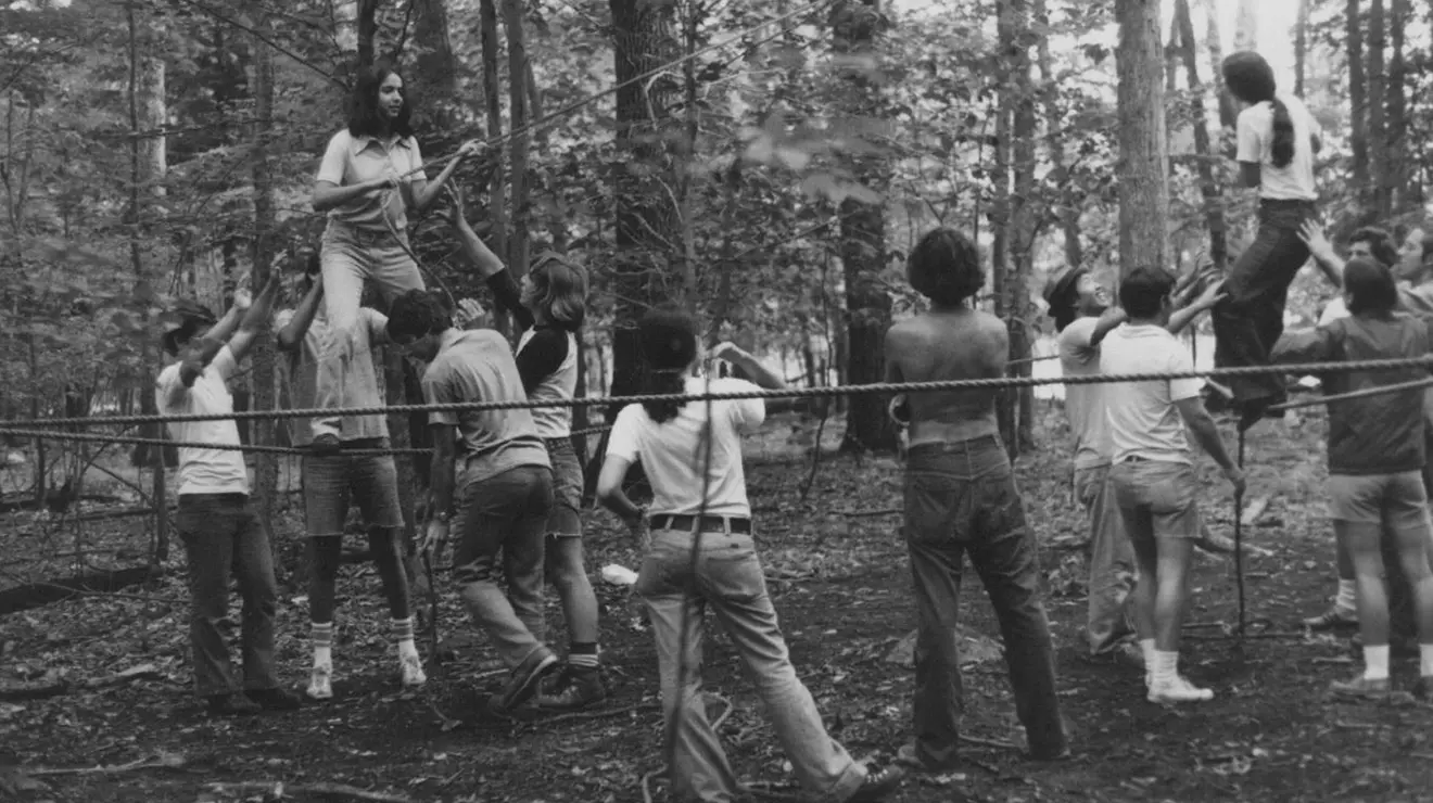OTC_OA_1974 Frosh Trip ropes course copy.png Students navigate a ropes course during the first Outdoor Action frosh trip in 1974