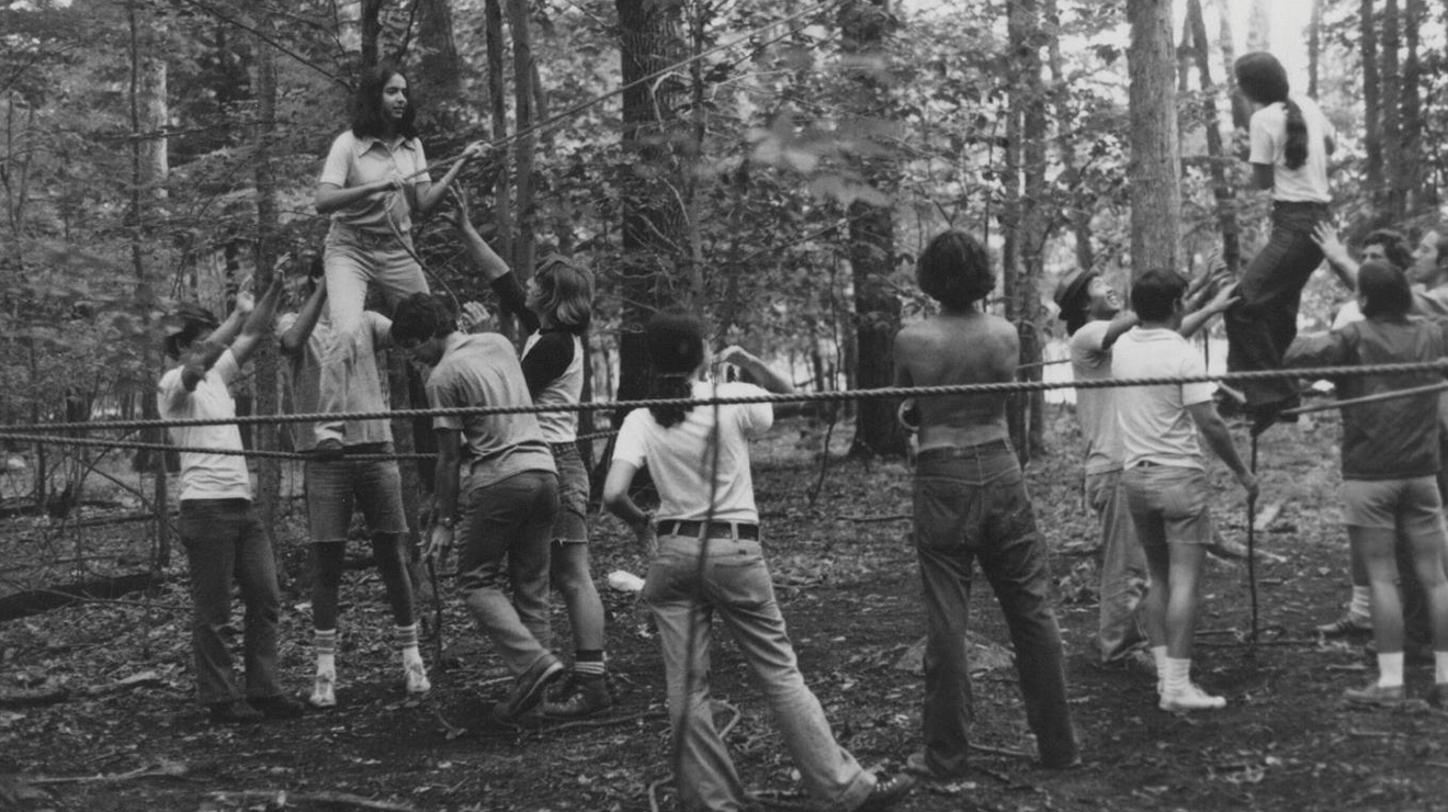 Students navigate a ropes course during the first Outdoor Action frosh trip in 1974