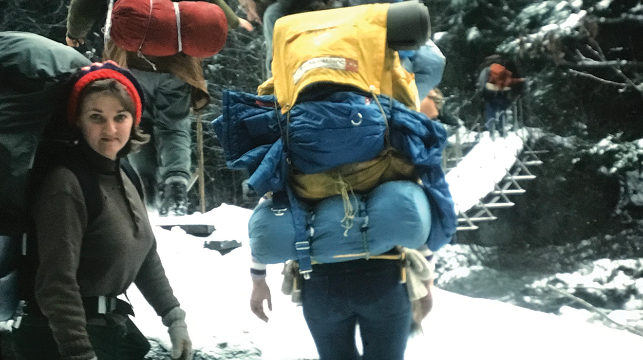 Hikers on the trail with snow on the ground