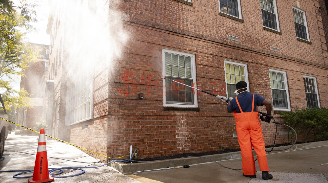 Red paint is washed off the exterior of 22 Chambers Street, the headquarters of the Princeton University Investment Co., which was vandalized.