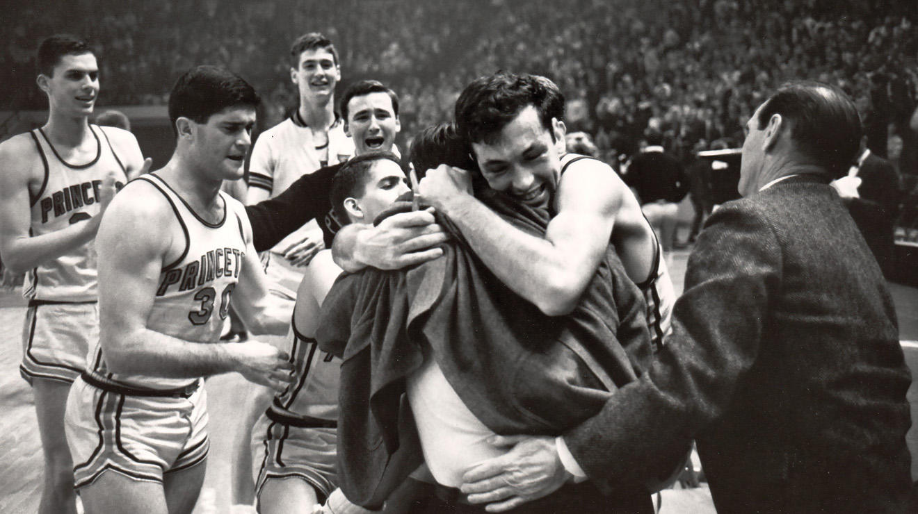 Bill Bradley ’65 embraces coach Butch van Breda Kolff ’45 after Princeton beat Providence to advance to the 1965 Final Four, the program’s only appearance in the men’s basketball national semifinals.