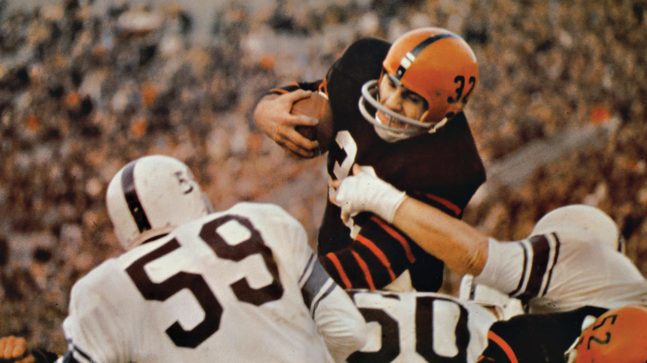 Cosmo Iacavazzi ’65 smashing through the defensive line during a game in 1963