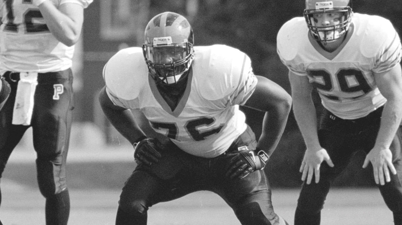 Dennis Norman ’01 lining up for a play in a black and white photo