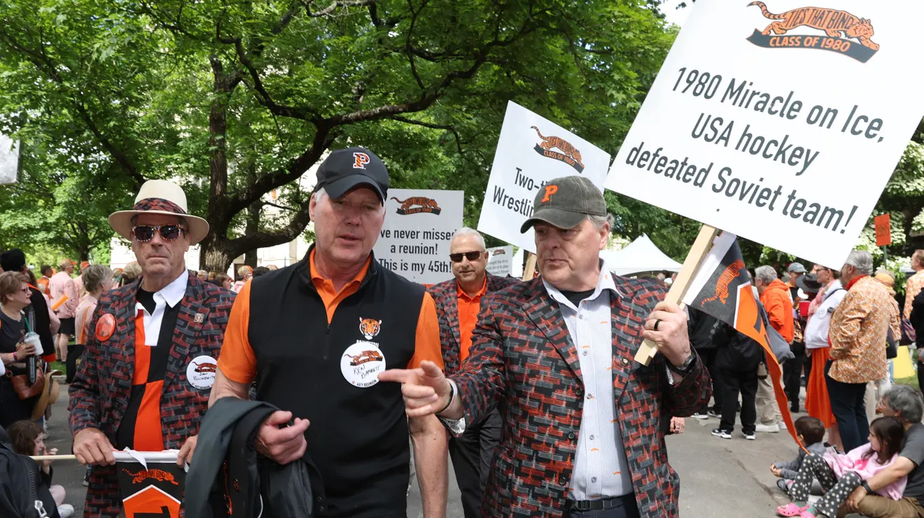 Retired Gen. Mark Milley ’80 in the P-rade holding a sign that says, "1980 Miracle on Ice USA hockey defeated Soviet team!"