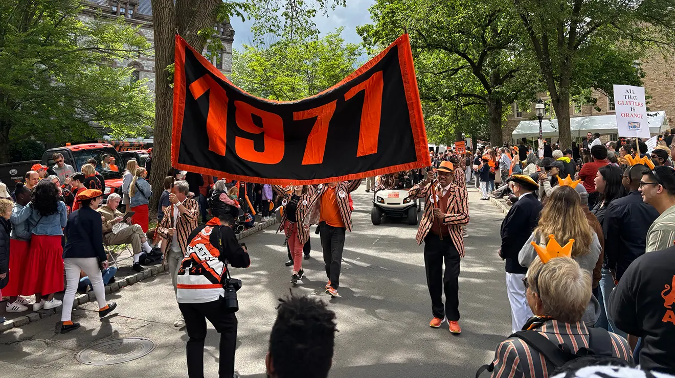 Alumni carry a 1977 banner in the 2025 P-rade.