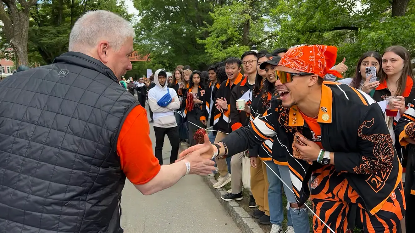 Two alumni shake hands at the 2025 P-rade.
