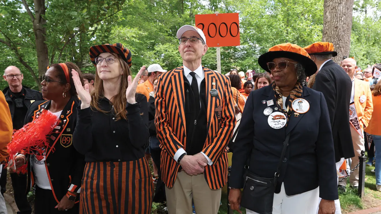 President Christopher Eisgruber ’83 is flanked by his wife, Lori Martin, left, and P-rade marshal Tonya Miles ’82.